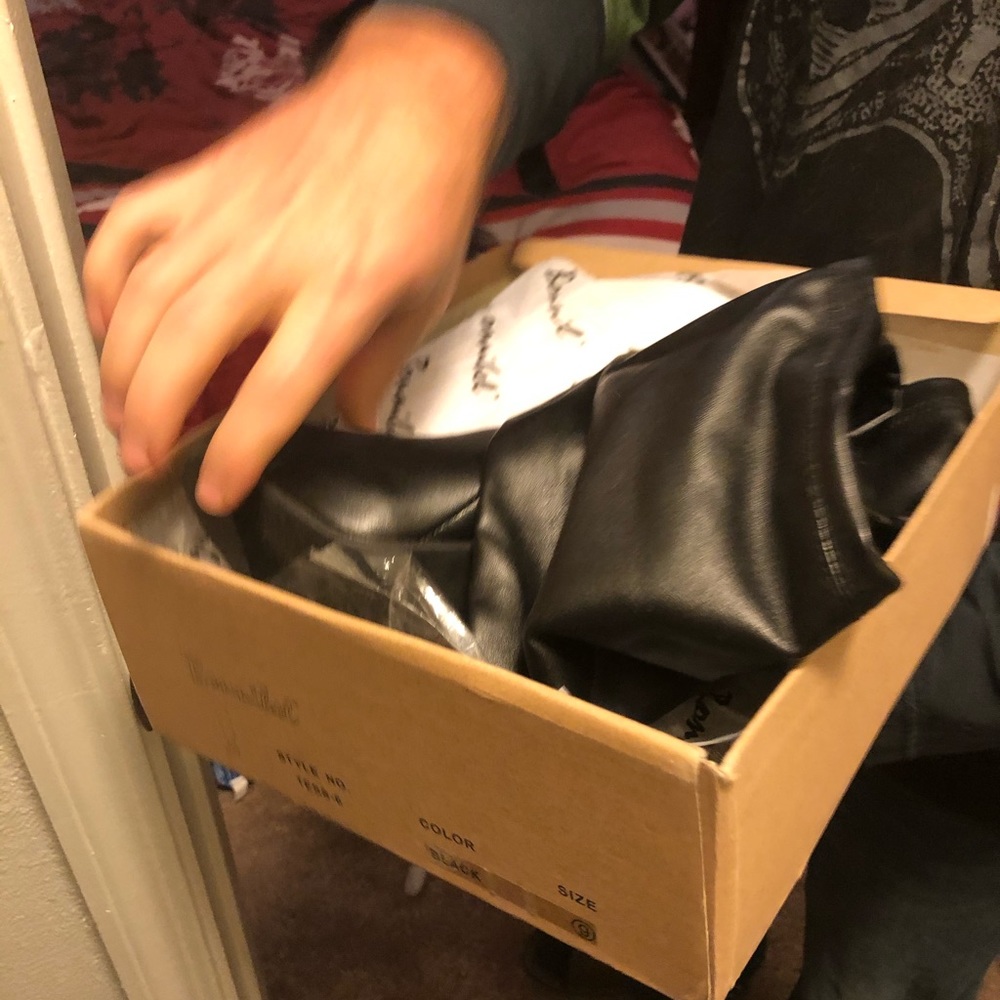 Black pleather thigh high boots.